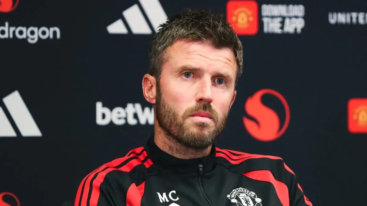Manager at press conference with Manchester United branding