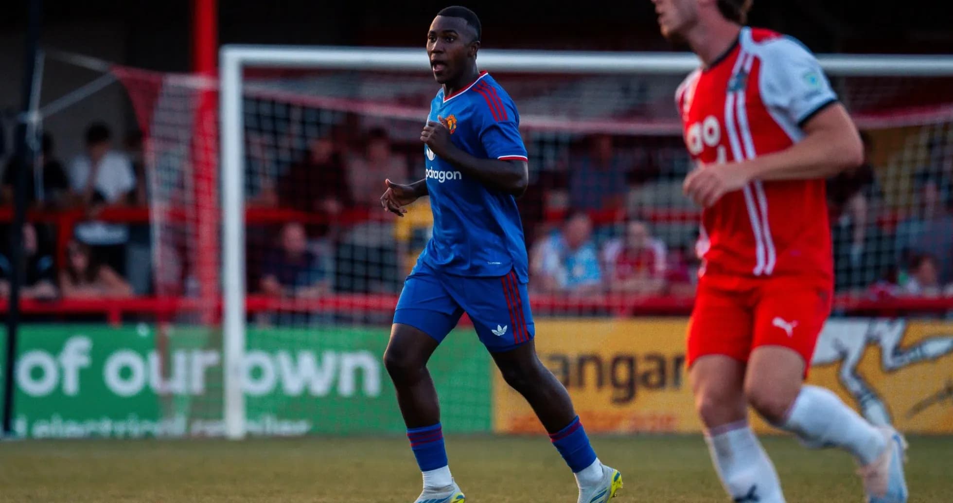 Player in blue kit running on the field