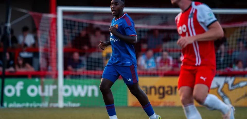 Player in blue kit running on the field