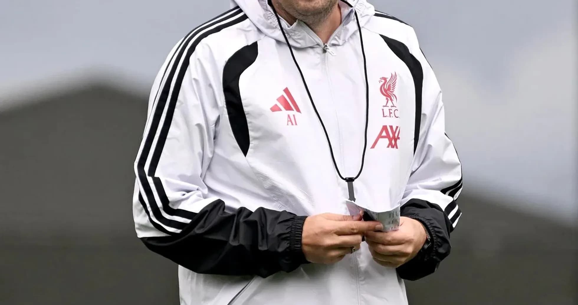 Coach wearing Liverpool training gear on field