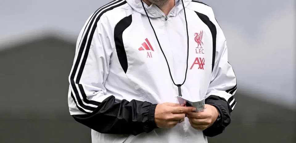 Coach wearing Liverpool training gear on field