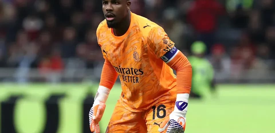 Goalkeeper in orange kit preparing for action