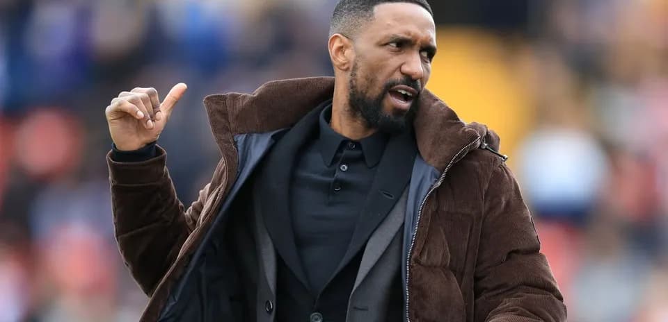 Coach gesturing during a football match on sidelines