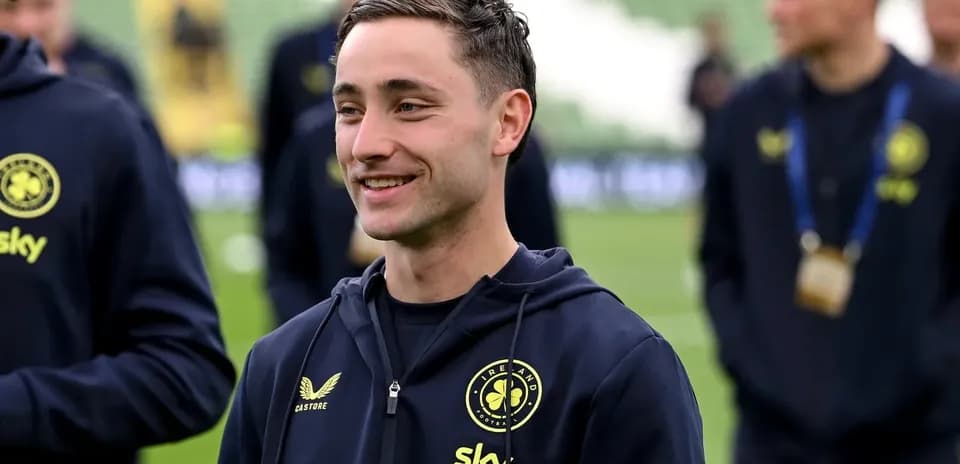 Player smiling during warm-up on the pitch