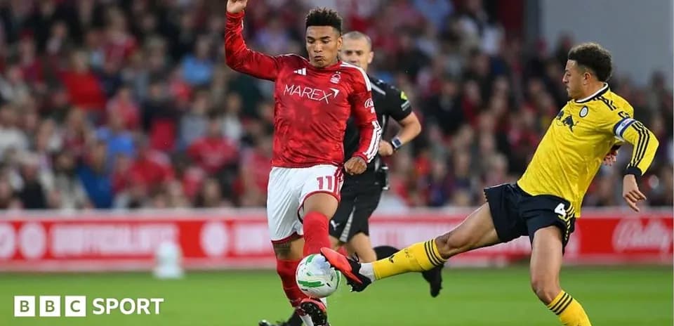 Player in red jersey challenged by opponent in yellow