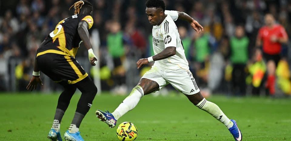 Vinicius Jr. dribbling past defender during match