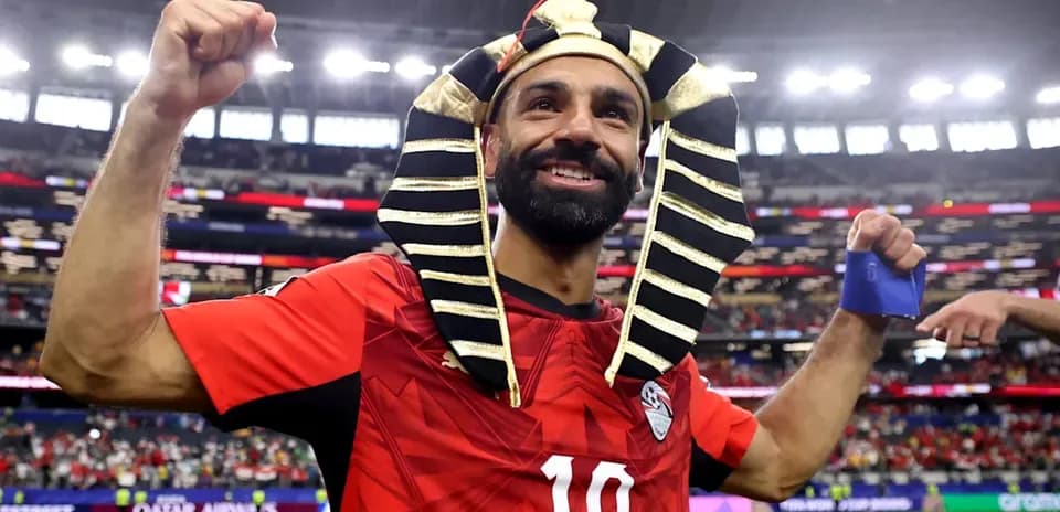 Player celebrating in Pharaoh headdress after match