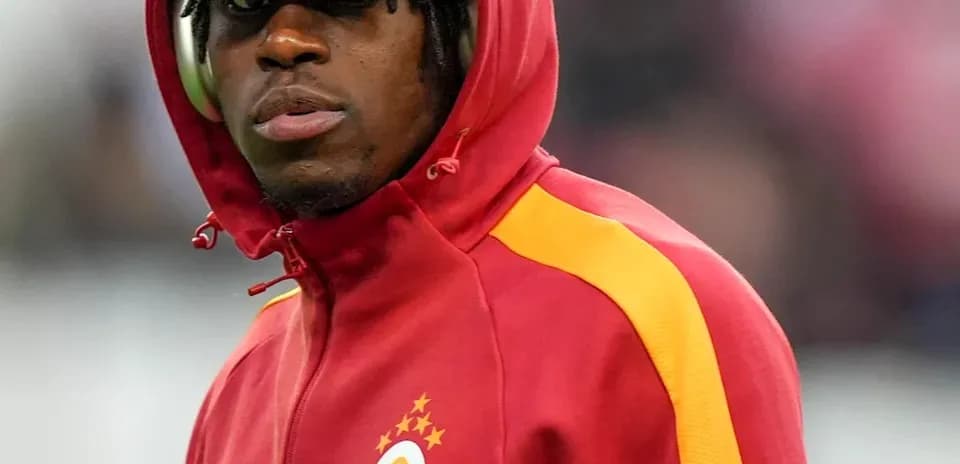 Player in red jacket with hood before match