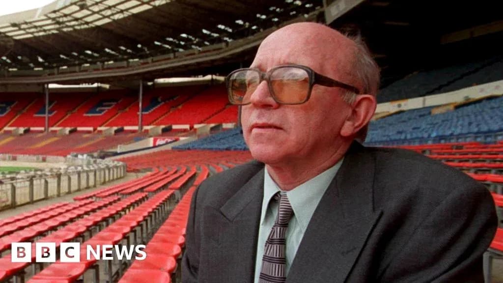 Man sitting in empty stadium seats, looking ahead