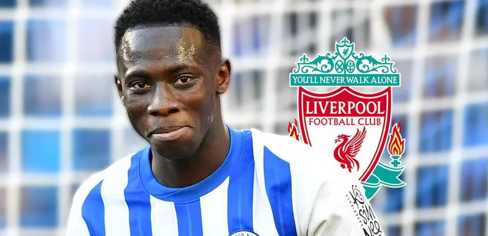 Football player smiling in Brighton kit with club logos