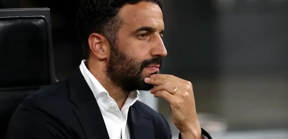 Man in suit with hand on chin, deep in thought