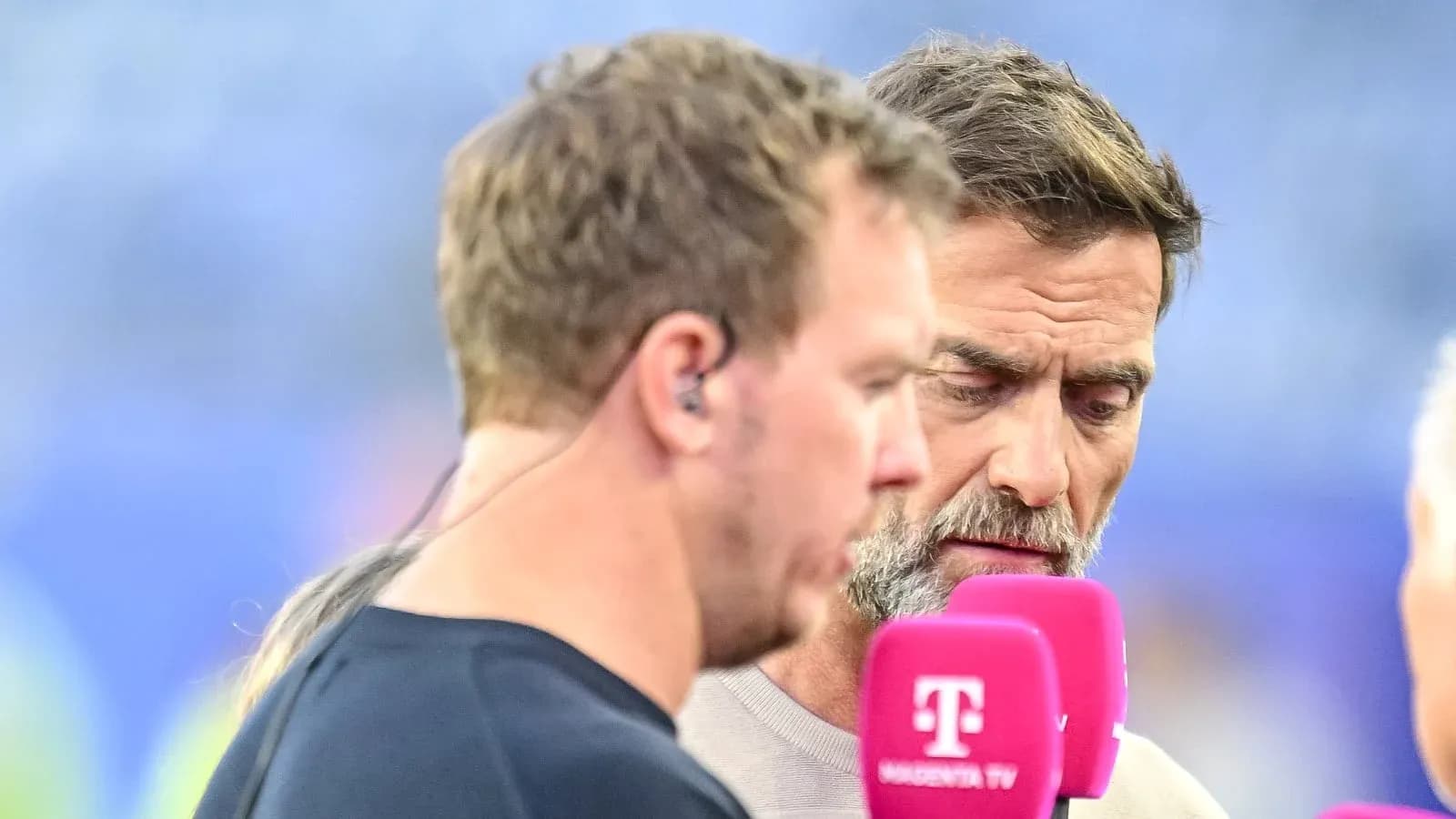 Two commentators discussing at a broadcast event