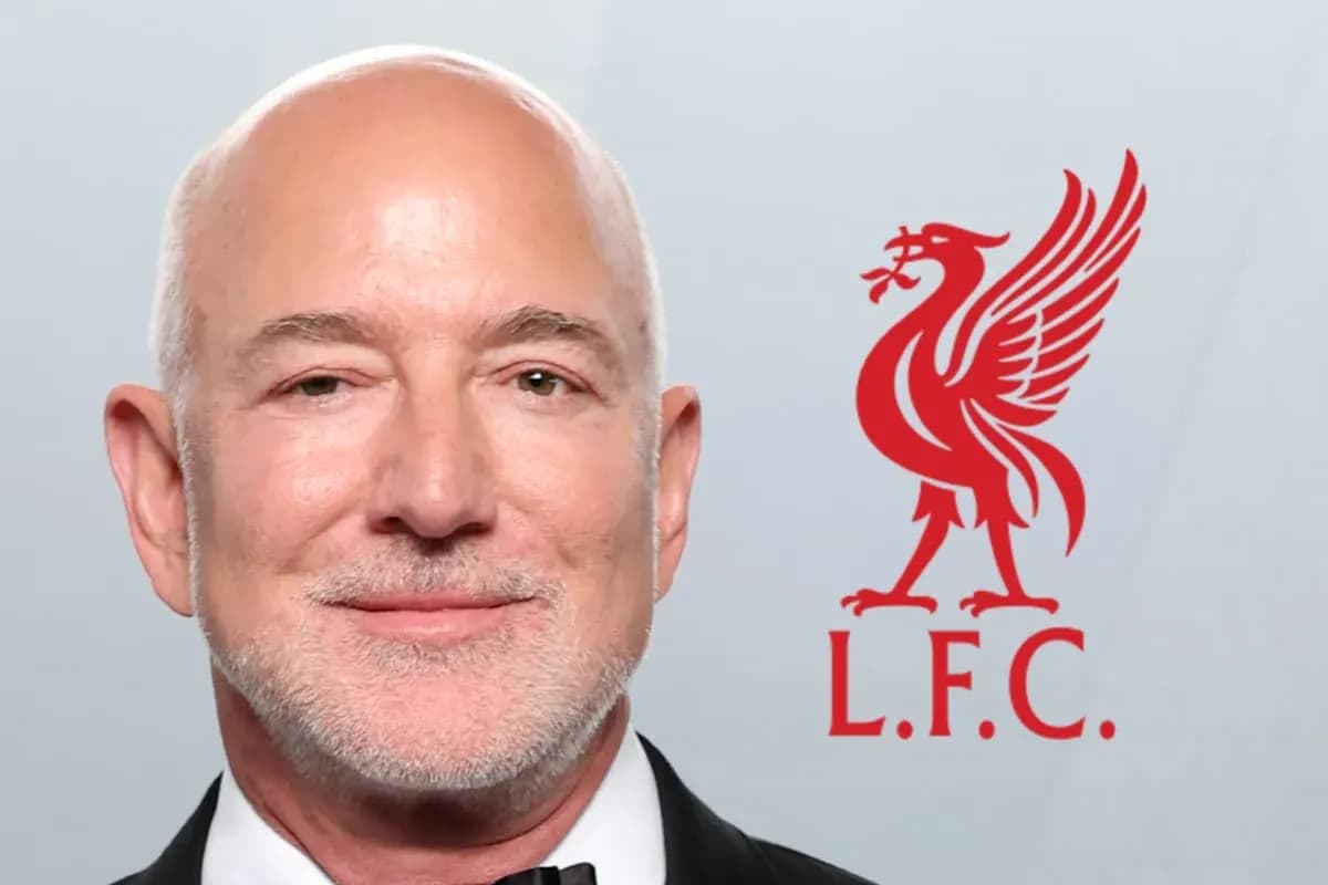 Person smiling with Liverpool FC logo in background