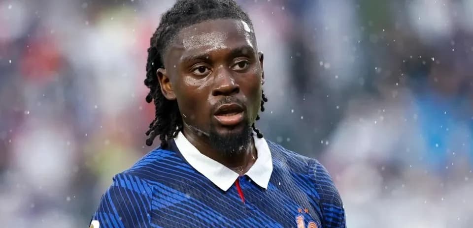 Player in blue jersey during rainy match
