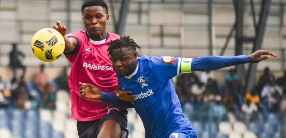 Two players contesting for the ball during match