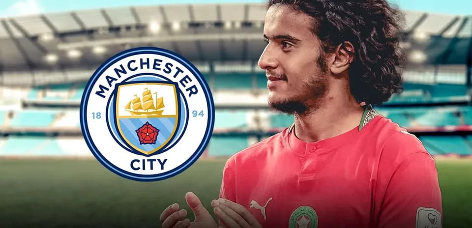 Player in Manchester City kit with stadium background