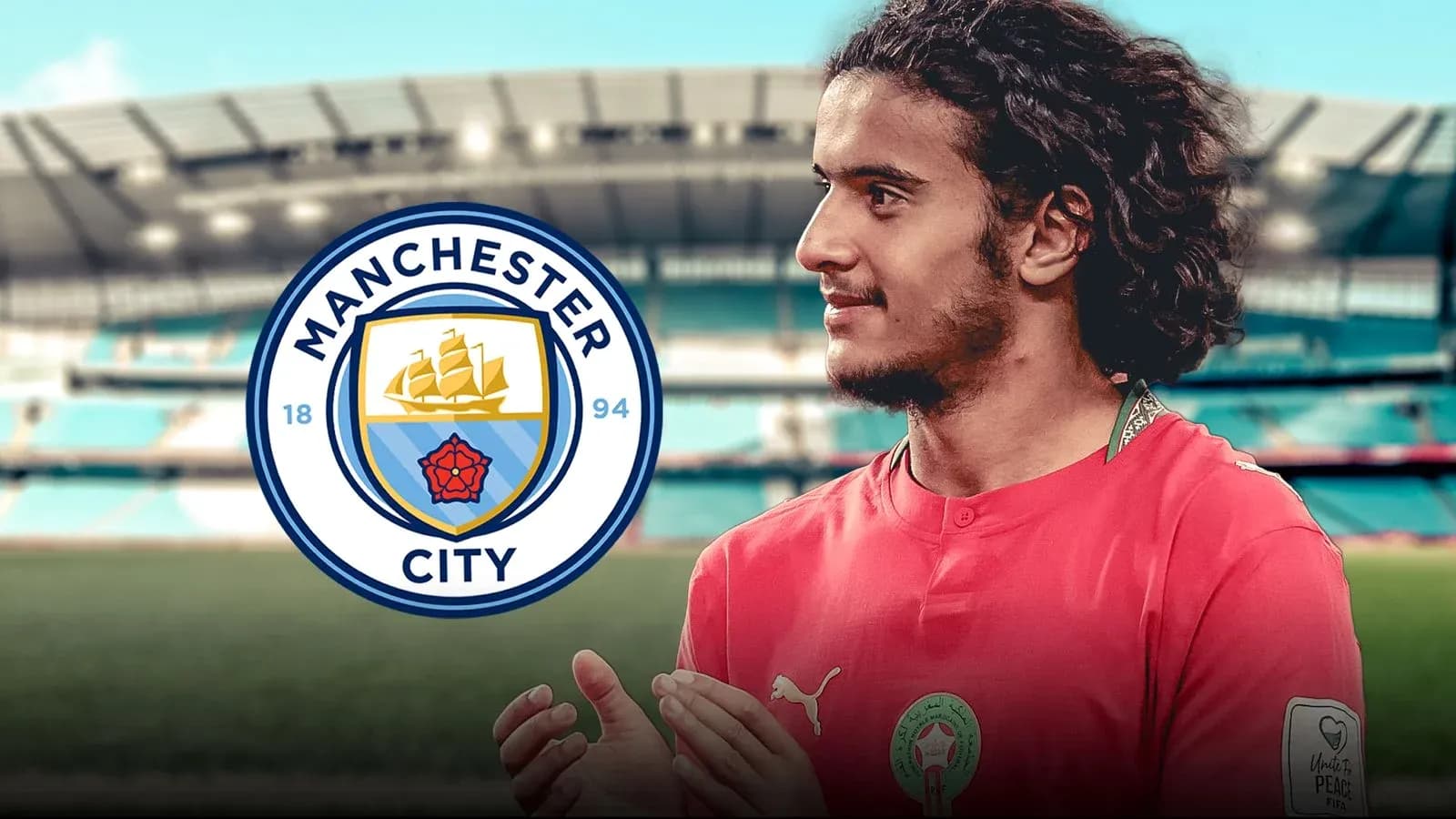 Player in Manchester City kit with stadium background