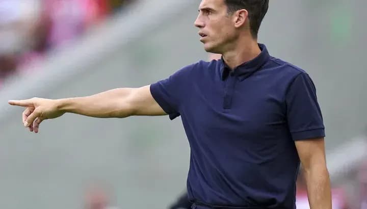 Coach gesturing during a match on the sidelines