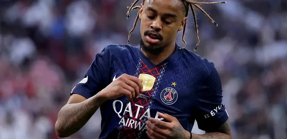 Player adjusting jersey with trophy emblem on chest