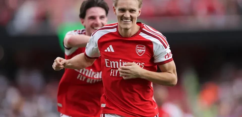 Arsenal players celebrating a goal on the pitch