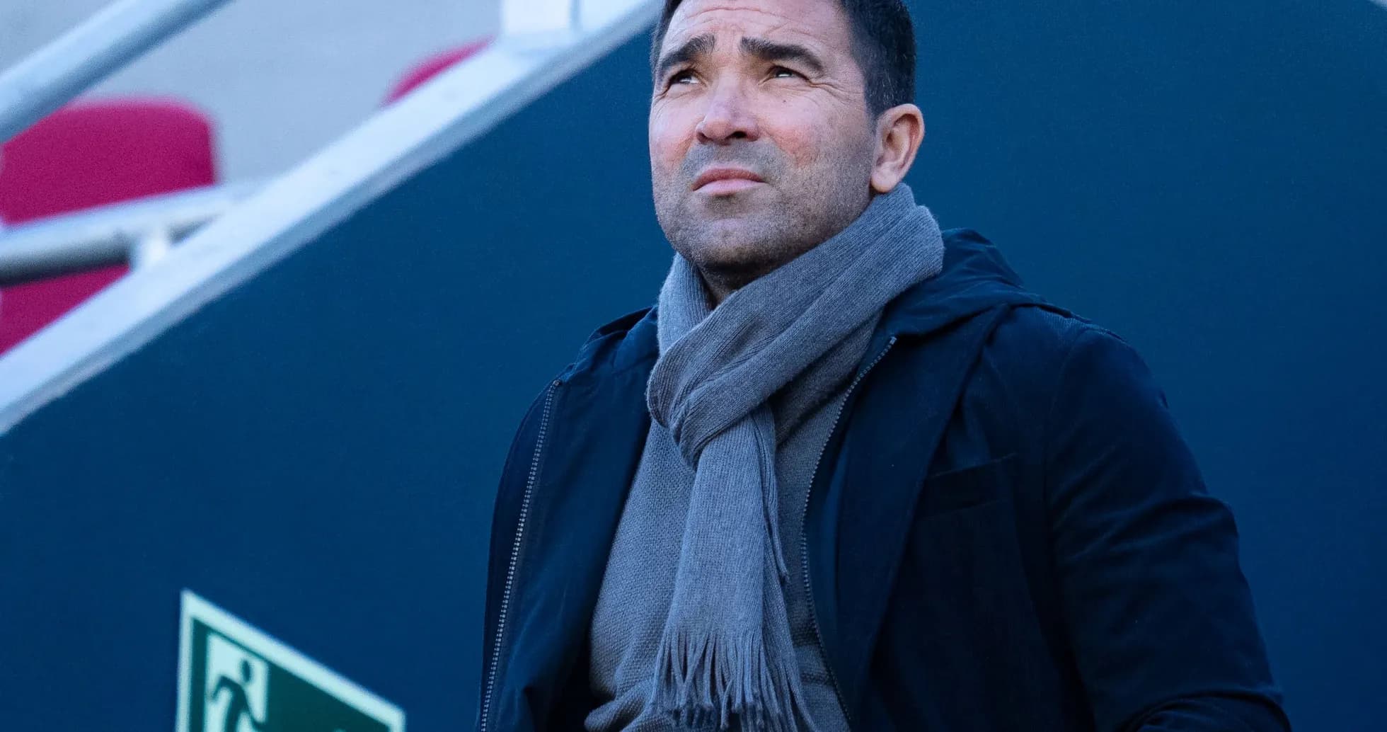 Man looking upwards, wearing a scarf and jacket