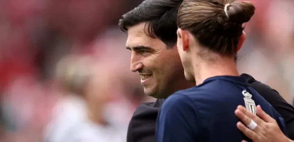 Coach and player embracing before the match