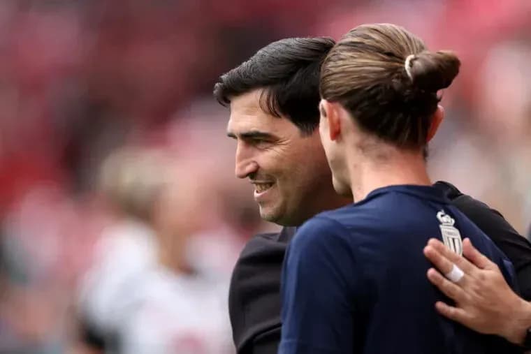 Coach and player embracing before the match