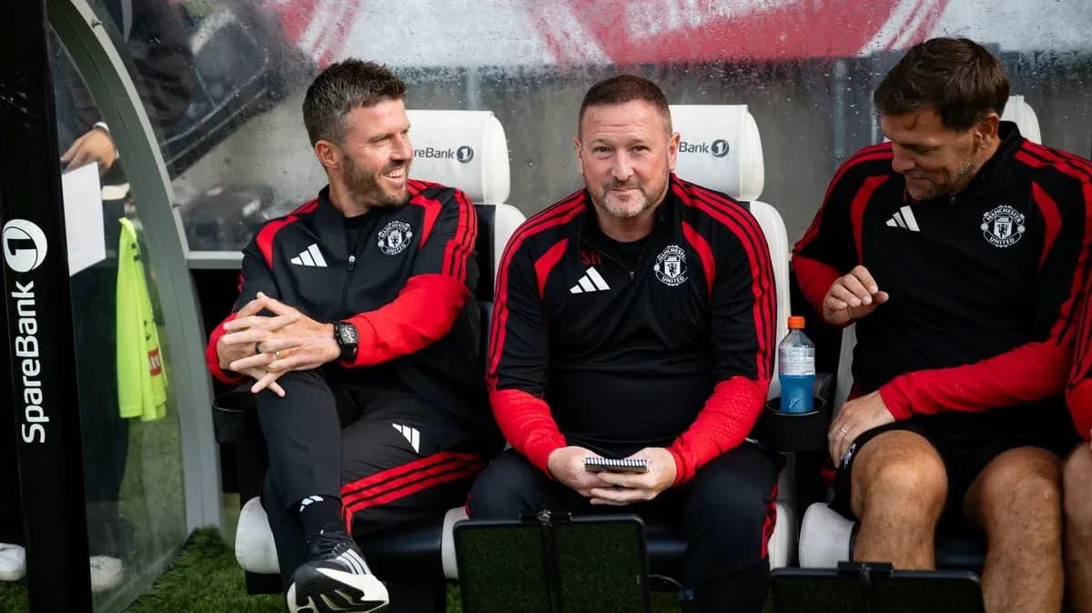 Coaching staff seated on bench during match