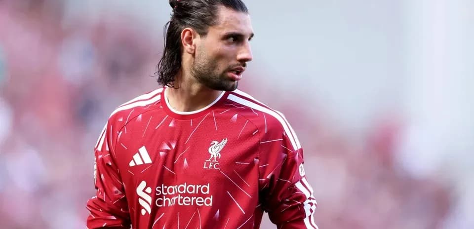 Goalkeeper wearing Liverpool kit on the pitch