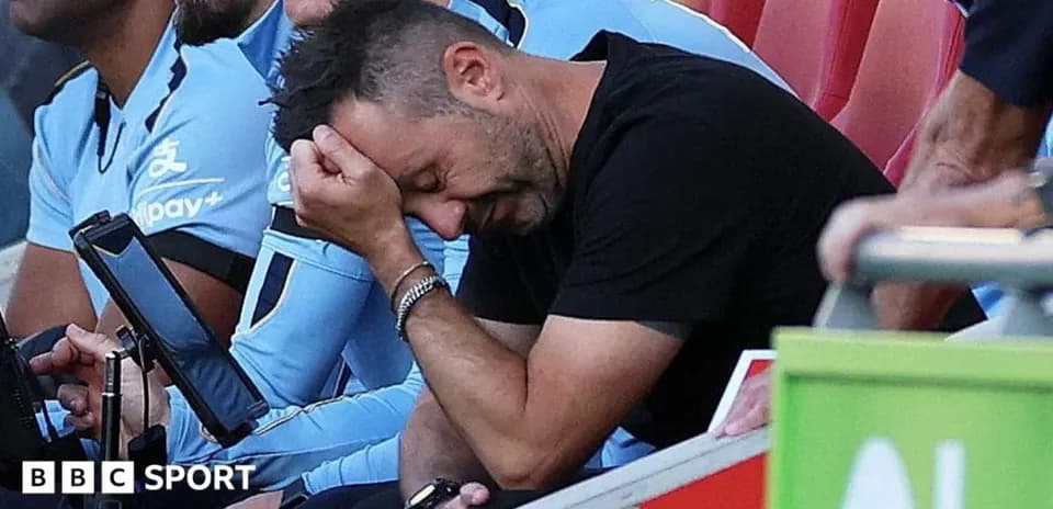 Coach with head in hands on the sidelines