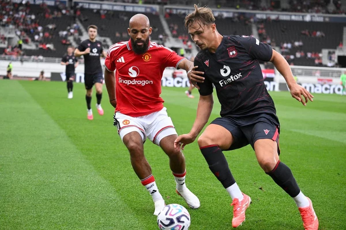 Two players contesting for the ball on field