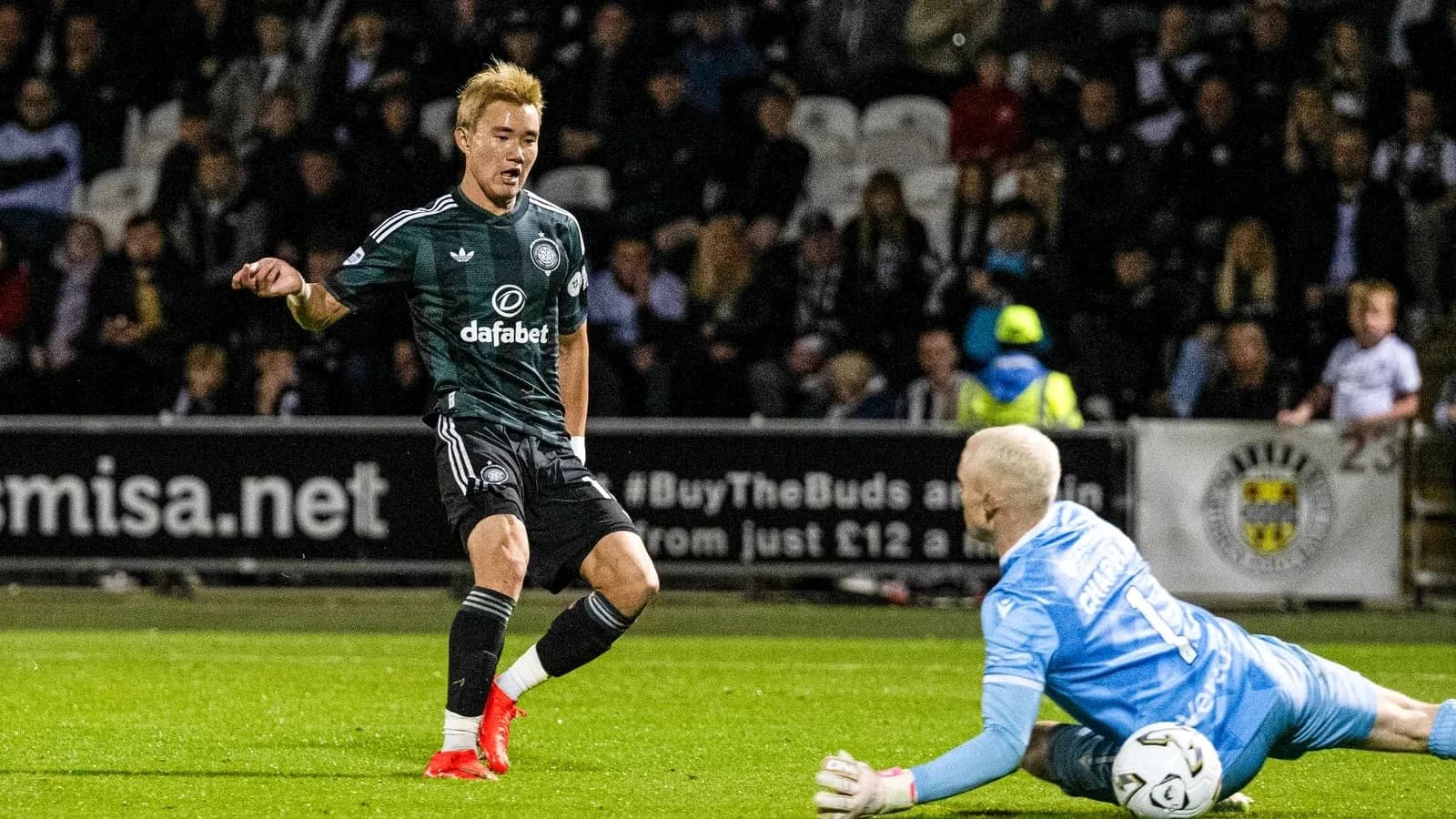 Player attempting to score against goalkeeper in match