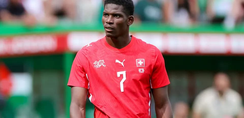 Player in red Swiss jersey on the field