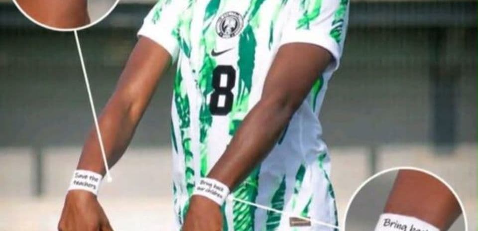 Player wearing Nigeria jersey with protest wristbands
