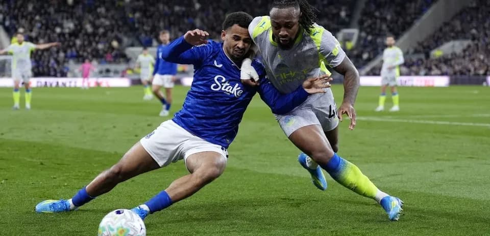 Two players battling for the ball during match