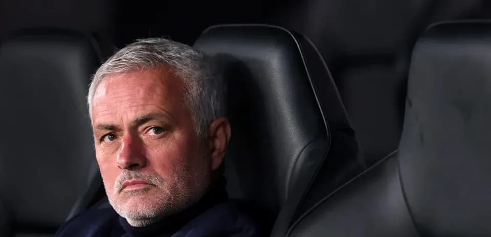 Manager sitting on bench during a match