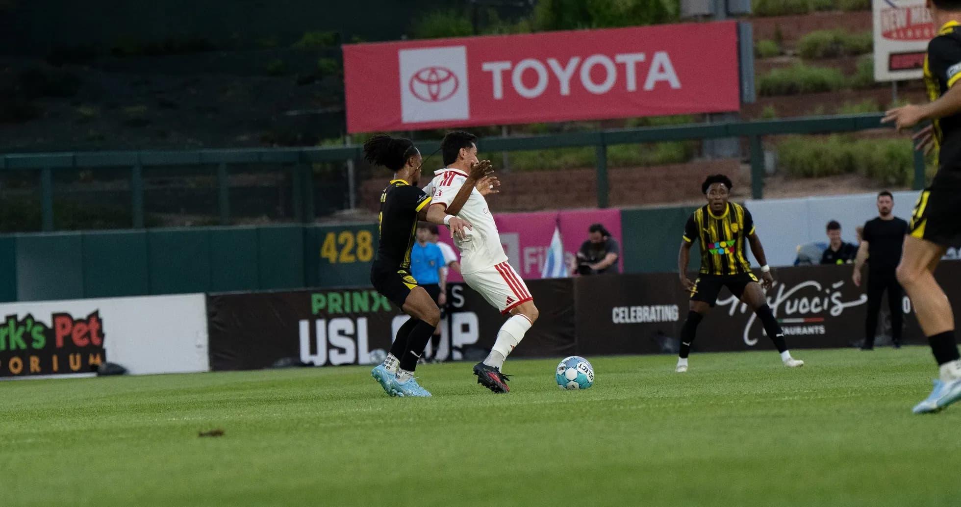 Players contesting for the ball in USL match