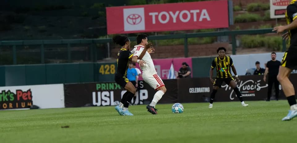 Players contesting for the ball in USL match