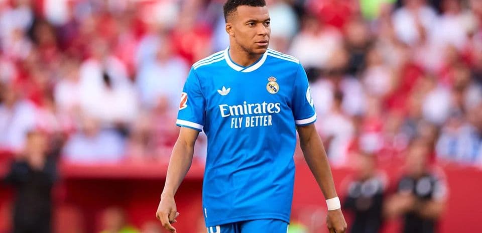 Player in blue jersey walking on the pitch