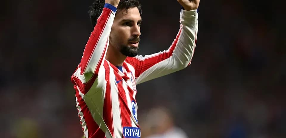 Player celebrating with raised fists on the pitch
