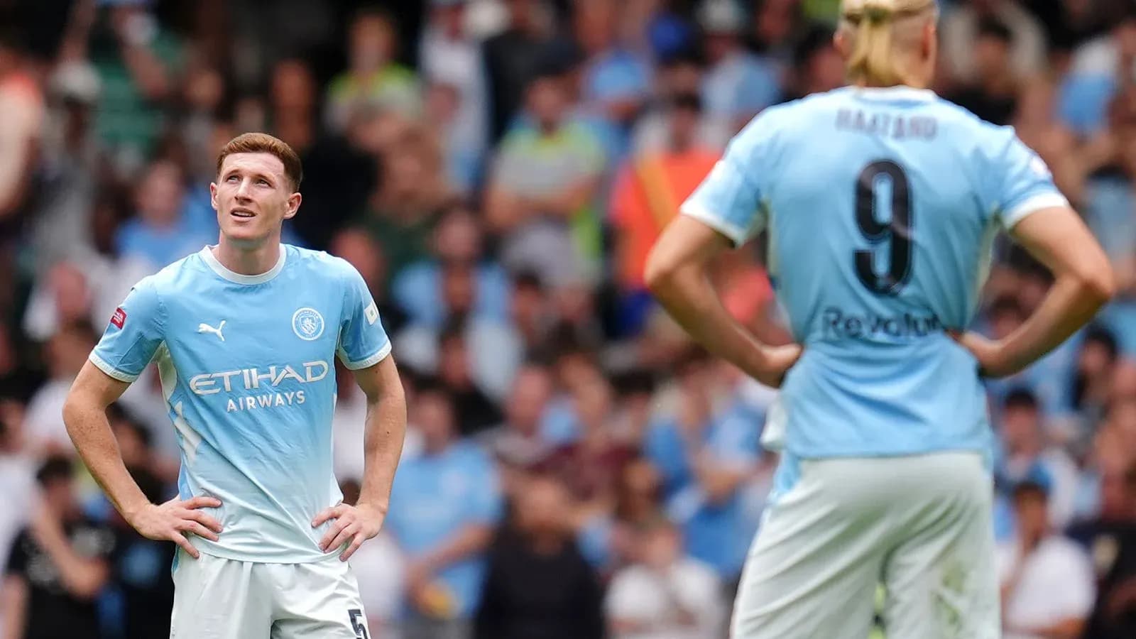 Two Manchester City players on the pitch during match