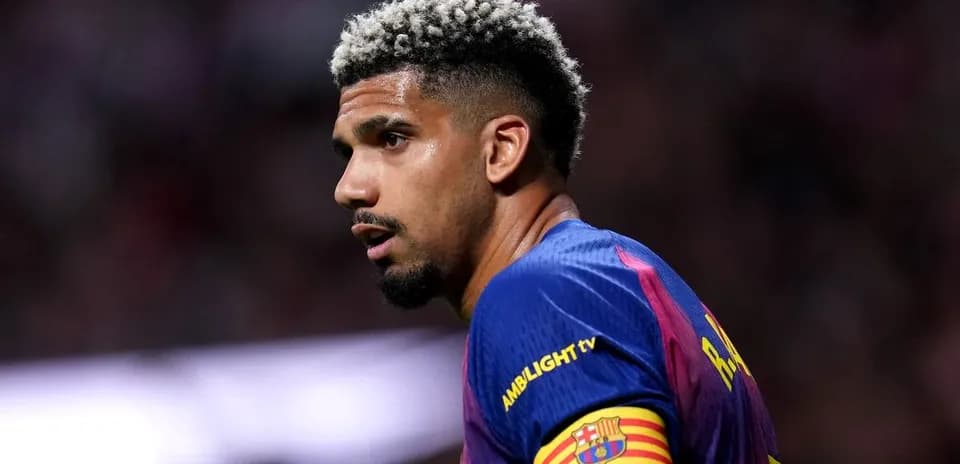 Player with blonde curly hair wearing Barcelona jersey