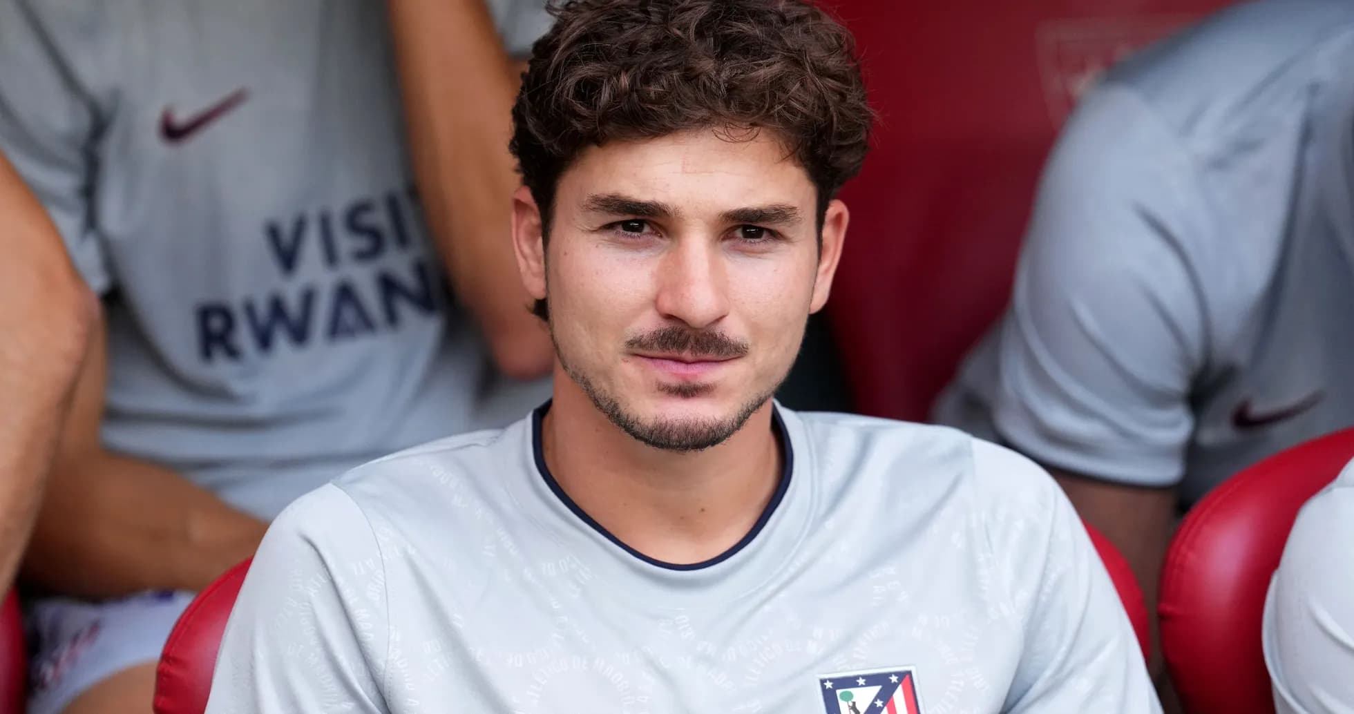Player sitting on bench during match warm-up