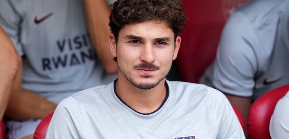Player sitting on bench during match warm-up