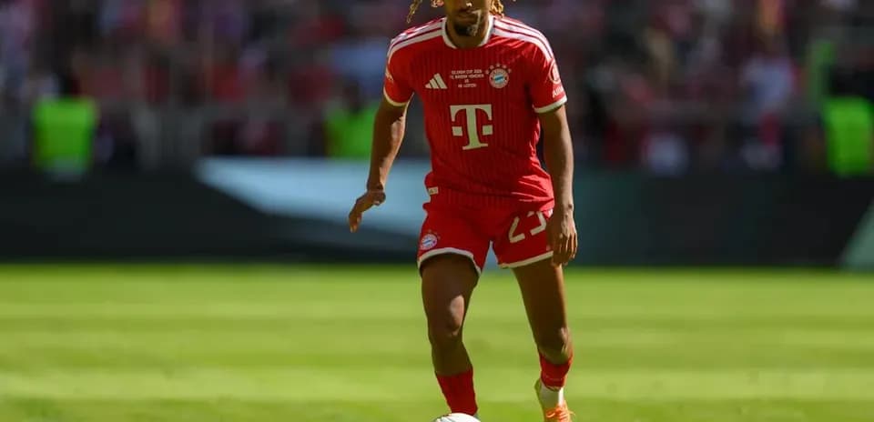 Player in red Bayern Munich kit running with ball