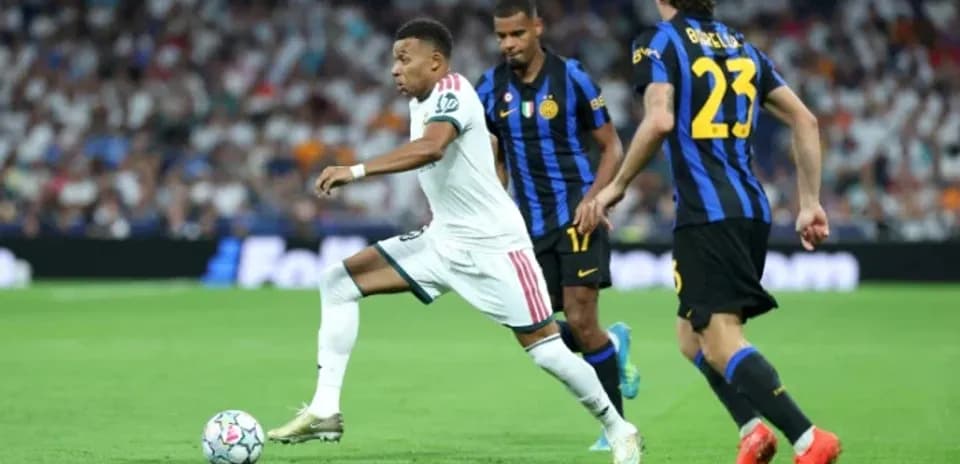 Mbappé dribbling past defenders during a match