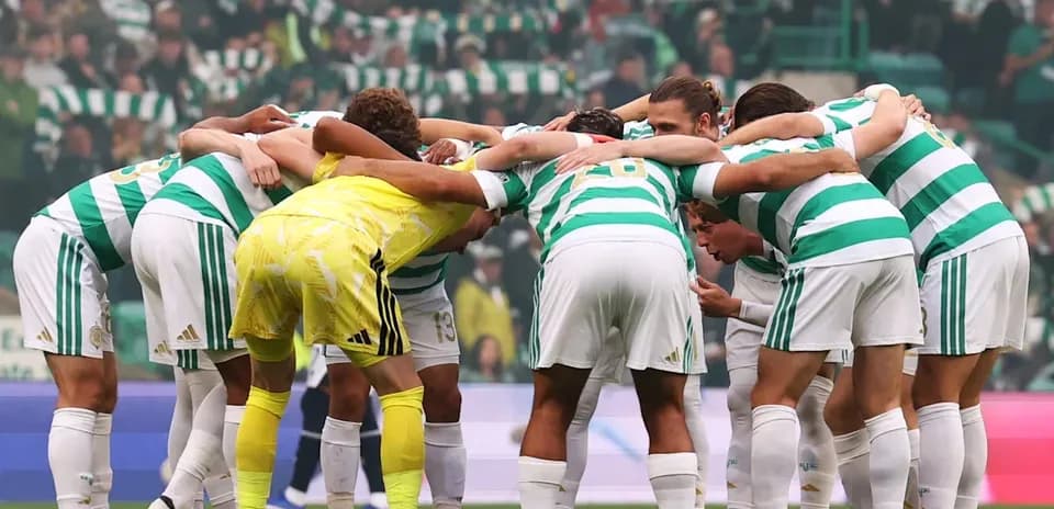 Celtic players huddled together on the pitch