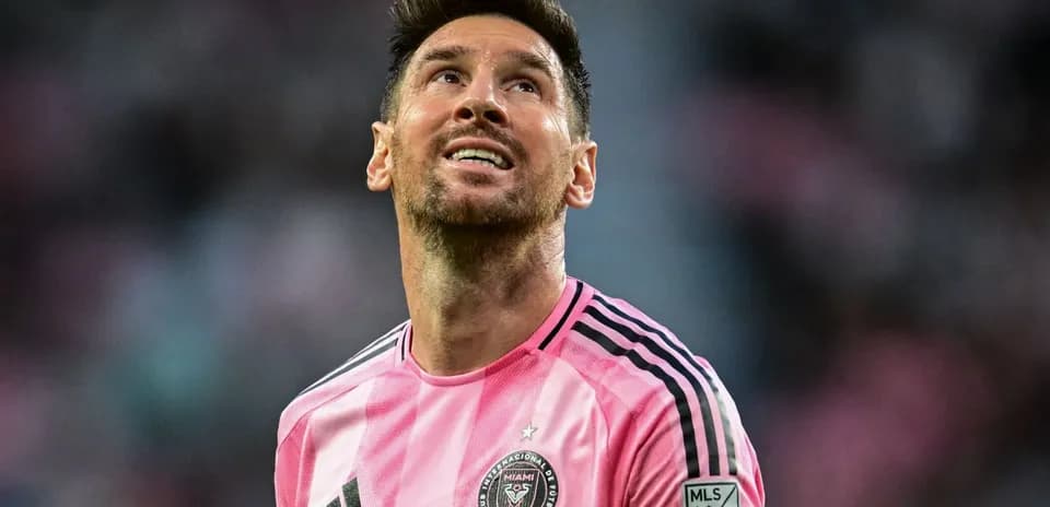 Player in pink jersey looking upwards on field
