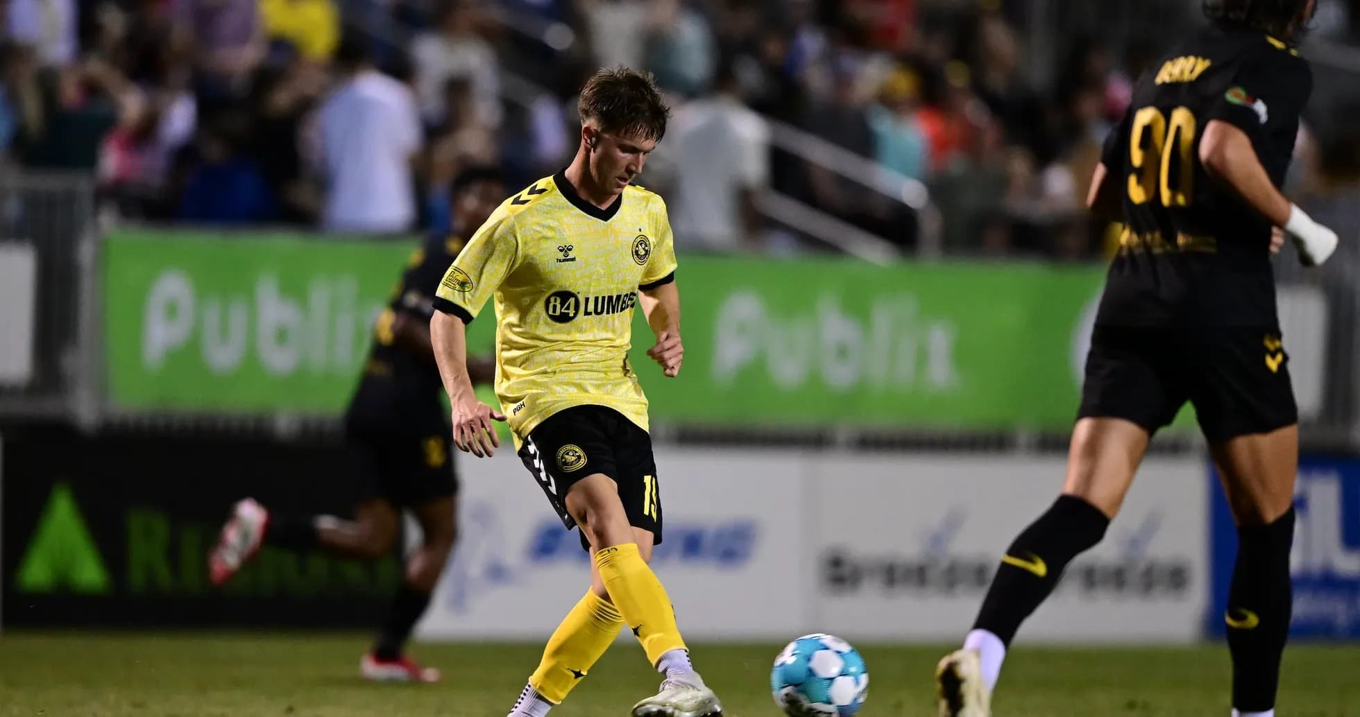 Charleston Battery player dribbling ball during match