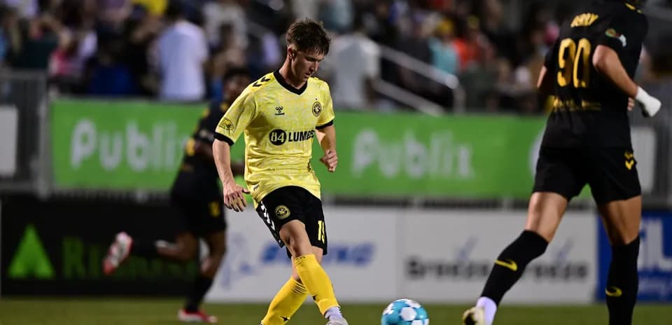 Charleston Battery player dribbling ball during match